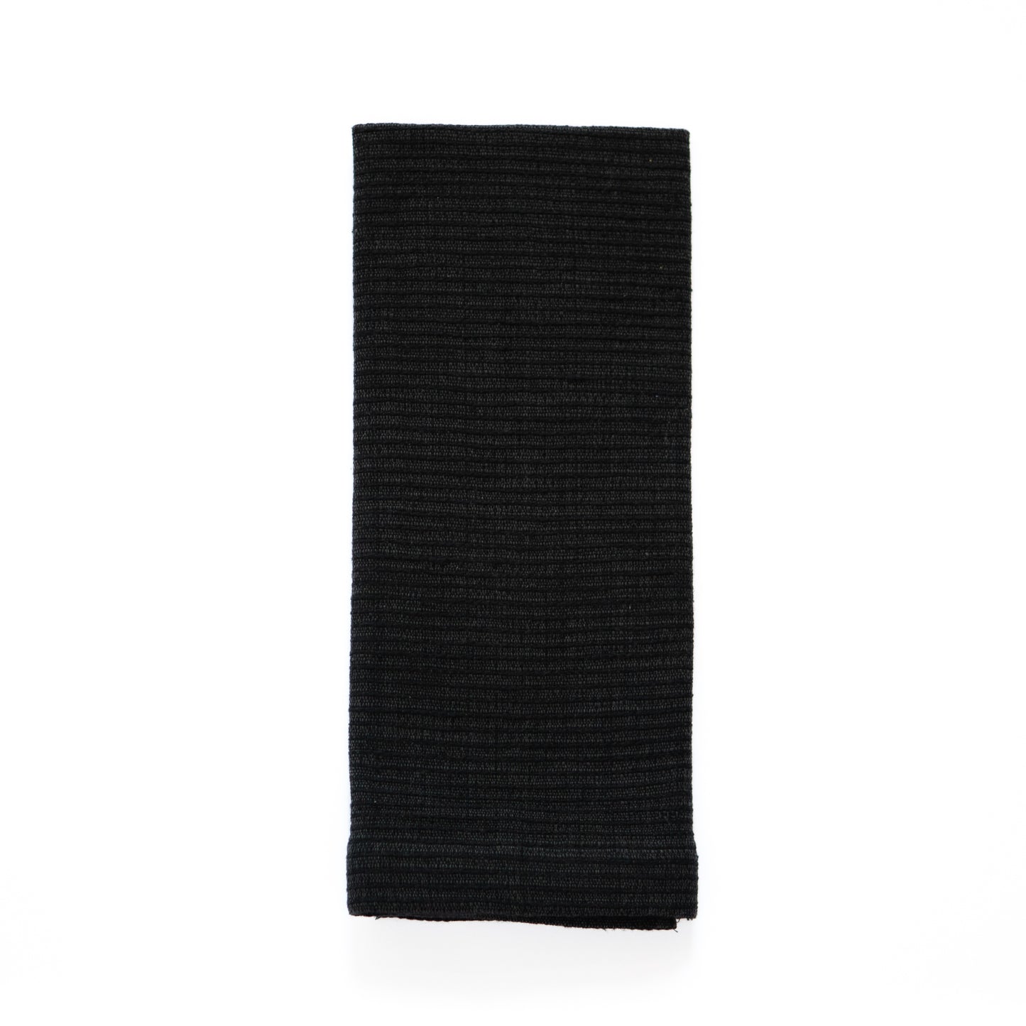 Zarima towel in black flat lay on white background