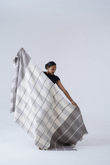 ayele blanket held by model against white background