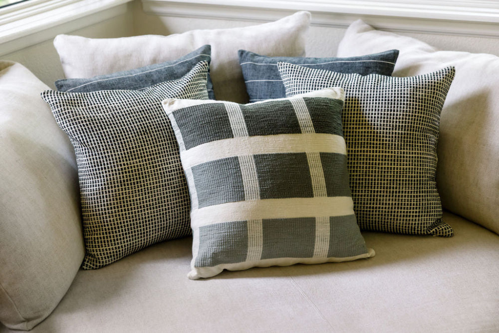 kare pillow in grey on couch with akobo and adama pillows in the background 