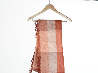 mareb towel in salmon hanging against white background