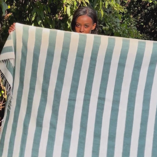 Omo bath towel in teal in the garden