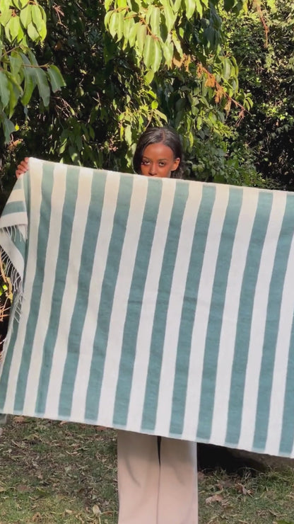 Omo bath towel in teal in the garden