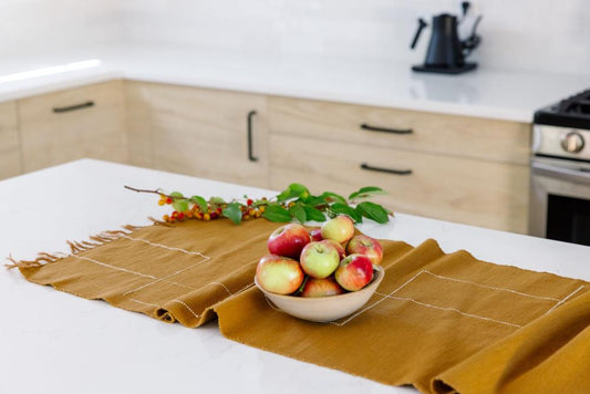 Rift Valley table runner in bronze with apples on a table