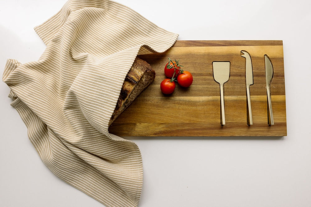 turkana tea towel in bronze with bread and cutlery 