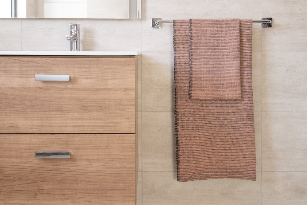 zarima bath towel and hand towel in blush in bathroom