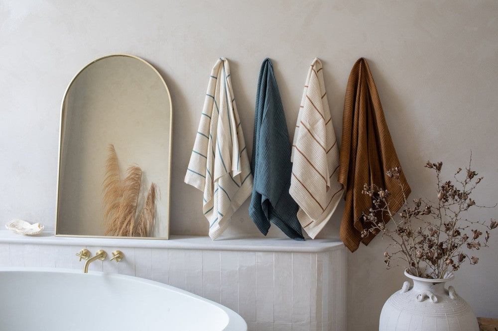 Wari and Karima bath towels hanging in bathroom