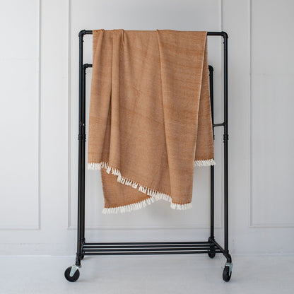 Mechot throw blanket in bronze on bar with white background