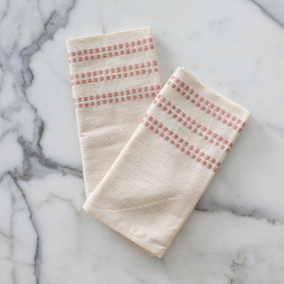 Two Sodo napkins in blush on a marble background