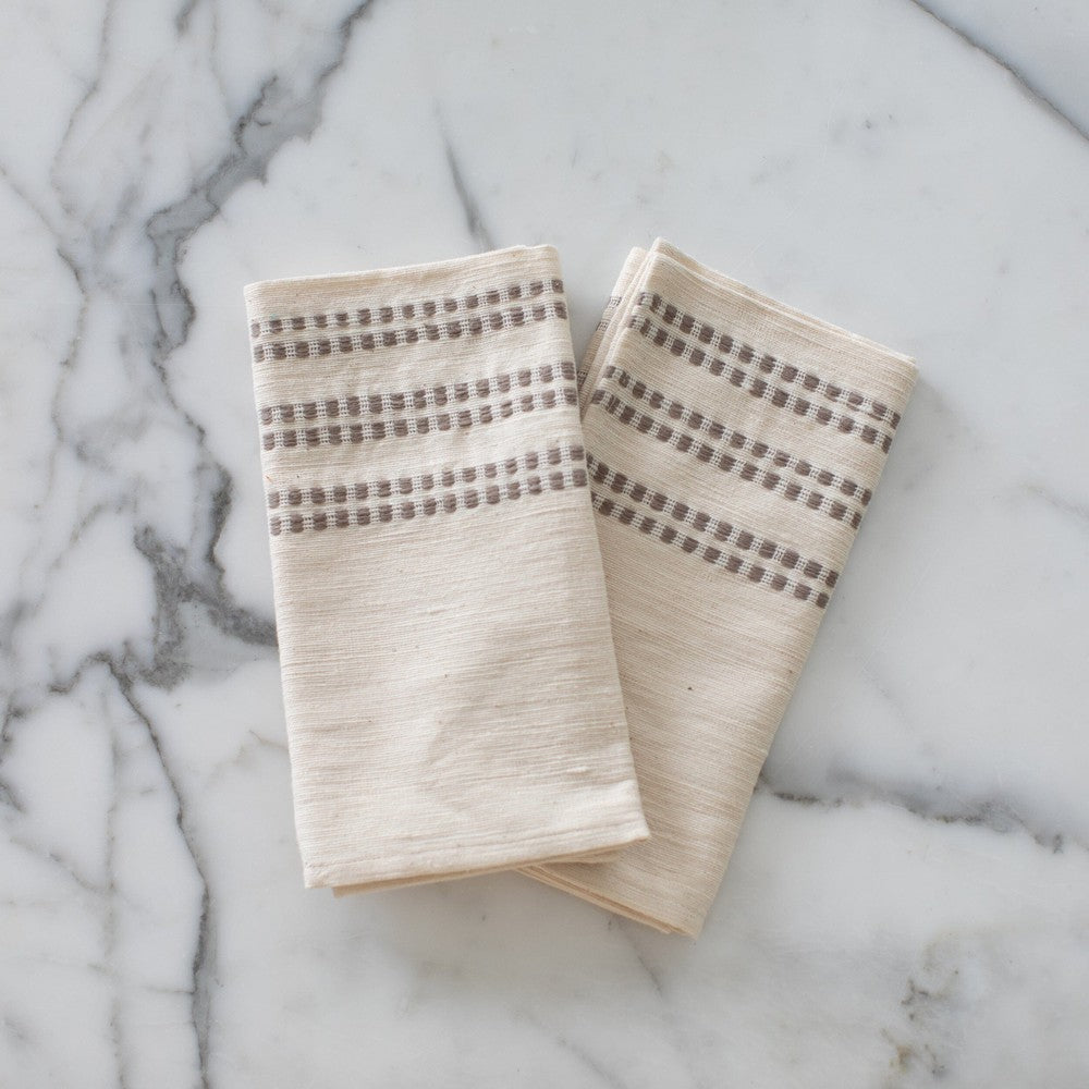 Two Sodo napkins in stone on a marble background