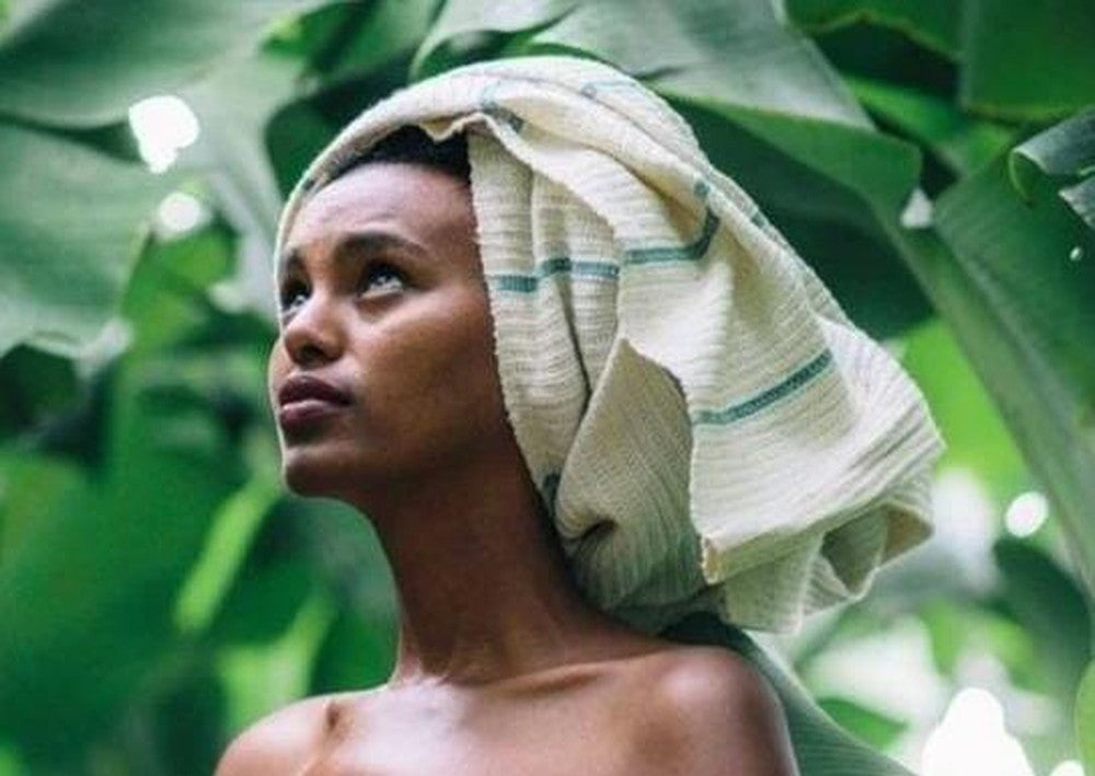 Wari waffle bath towel in flax wrapped around model's hair